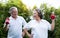 Asian Senior Couple exercising with red dumbbells at the outdoor