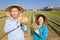 Asian senior couple farmer holding pumpkin