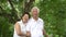 Asian senior couple smiling happy green tree background