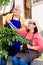 Asian senior couple smiling while watering green cultivated plan