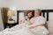 Asian senior couple talking on bed at home. Asian Senior Chinese grandparents, husband and wife happy drink coffee after wake up