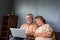 Asian senior couple talking in video call chat on laptop computer.