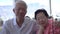 Asian senior couple travel to Cape Town, South Africa happy at restaurant