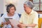 Asian senior couple use tablet searching about retirement financial document sitting on sofa at home,senior learn to use