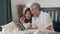 Asian senior couple using tablet at home. Asian Senior Chinese grandparents, video call talking with family grandchild kids while