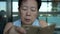 Asian senior elder woman using smartphone chatting through social media while sitting close-up shot