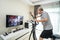 Asian Senior Elderly man workout cardio on cycling exercise bike machine at home for well being. Active Older male doing lockdown