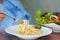 Asian senior or elderly old lady woman patient eating carbonara spaghetti and salad vegetable breakfast