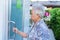 Asian senior elderly old lady woman patient open toilet bathroom by hand in nursing hospital ward