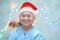 Asian senior or elderly old lady woman patient with Santa Claus helper hat very happy in christmas