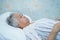 Asian senior or elderly old lady woman patient smile bright face with strong health while lying on bed in nursing hospital ward