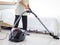 Asian senior elderly woman housewife vacuuming the floor at bedroom with vacuum cleaner, grandma doing housework at house