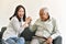 Asian senior father having fun with smiling daughter.