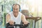 Asian senior man on exercise bike the gym.