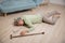 Asian senior man falling down lying on floor at home alone with wooden walking stick