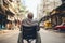 Asian senior man sitting in wheelchair on the street in Hong Kong, An old man is sitting in a wheelchair on a walk in the city,