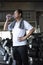 Asian senior man thirsty drinking water after exercise in fitness gym. elderly healthy lifestyle