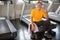 asian Senior man tired taking break after exercise sitting or resting on treadmill and show thumbs up  in fitness gym . walking