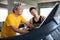 asian Senior man walking exercise on treadmill with Personal trainer workout in fitness gym . sport trainnig , retired , older ,