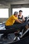 asian Senior man walking exercise on treadmill with Personal trainer workout in fitness gym . sport trainnig , retired , older ,