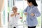 Asian senior people sitting relax with walker during rehabilitation and young carer,elderly woman or mother smiling and exercise