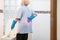 Asian senior woman in blue glove,cleaning toilet bowl,female elderly housekeeper hands touching back pain having backache,muscle,