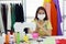 Asian senior woman designer wearing a mask at workplace to prevent the corona virus outbreak