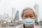 Asian senior woman with face mask protection,elderly woman wearing face mask because of air pollution in the city building as