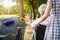 Asian senior woman hand holding plastic bottle,putting plastic water bottle in recycling bin,elderly tourist hand throwing garbage