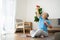 Asian senior woman lifting dumbbell for exercise and workout at home. Active mature woman doing stretching exercise in living room