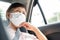 Asian Senior woman Passenger wear surgical mask for prevent and protection coronavirus or Covid-19 while sitting in car. Public