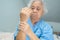 Asian senior woman patient feel pain her hand on bed in nursing hospital ward, healthy strong medical concept