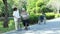 Asian senior woman practice walking exercise with barefoot on grass to release static electricity from body onto the ground,