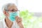 Asian senior woman suffer from cough with face mask protection,elderly woman wearing face mask because of air pollution,Sick old