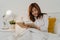 Asian senior women relax at home. Asian Senior Chinese female enjoy rest time read book while lying on bed in bedroom at home at