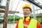 Asian senior worker engineer wearing helmet and safety clothes in the house construction site. Working elderly people concept