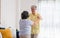 Asian seniors couple enjoy dancing in living room at home.aging at home concept