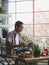 Asian senoir man relaxing while reading newspaper in his home house plant garden