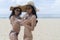 Asian Sexy young girls in bikini, enjoy wearing straw hat and sunglass, using camera and checking photo to camera together. Travel