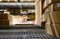 Asian shopper man standing between cardboard box shelves in warehouse choosing what to buy. shopping warehousing or packing