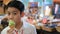 Asian siblings enjoying with ice cream cone in gift shop