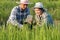 Asian smart farmer couple using digital tablet monitoring and  managing rice field organic farm. Modern technology smart farming