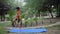 Asian smart kid doing yoga pose in the society park outdoor, Children\'s yoga pose. The little boy doing Yoga and meditation