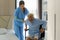 Asian smiling nurse helping senior man get out of bed nursing care support patient while getting out of bed and moving to