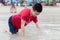 Asian special child playing sand and crawls happily on the beach