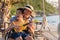 Asian special child on wheelchair is singing, playing ukulele happily on the beach