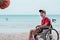 Asian special child on wheelchair is smiling, playing, doing activity on  sea beach