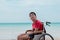 Asian special child on wheelchair is smiling, playing, doing activity on  sea beach on summer