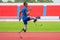 An Asian speed runner athlete with two prosthetic blades is captured practicing his speed running on the stadium\\\'s track
