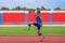 An Asian speed runner athlete with two prosthetic blades is captured practicing his speed running on the stadium\'s track